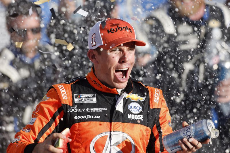 Ross Chastain celebrates in Victory Lane after winning a NASCAR Cup Series auto race at Kansas Speedway in Kansas City, Kan., Sunday, Sept. 29, 2024. (AP Photo/Colin E. Braley)