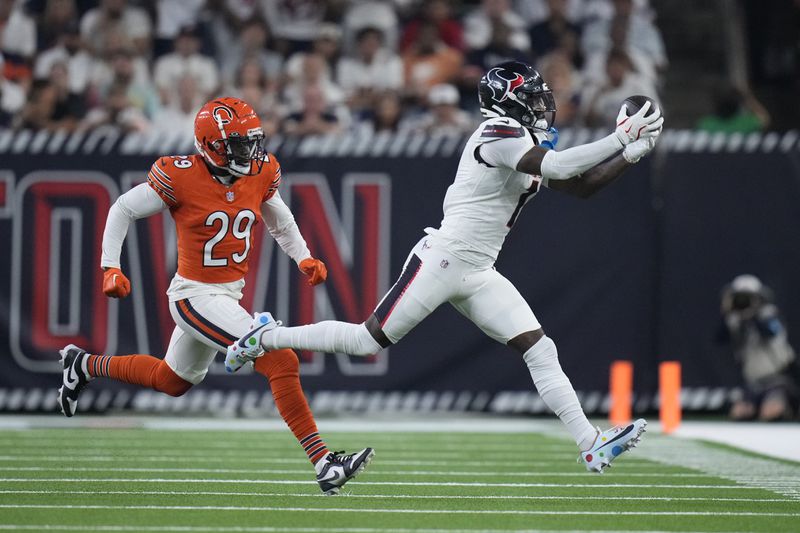 Houston Texans wide receiver Stefon Diggs, right, catches a pass for a first down as Chicago Bears defensive back Tyrique Stevenson (29) defends during the first half of an NFL football game Sunday, Sept. 15, 2024, in Houston. (AP Photo/Eric Gay)