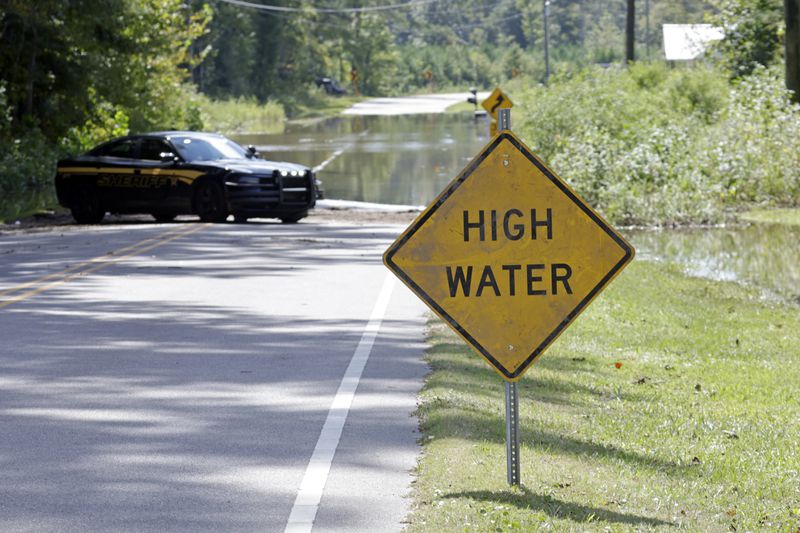 Flooding closes part of Stone Chimney Road in Supply, N.C., Tuesday, Sept. 17, 2024. (AP Photo/Chris Seward)