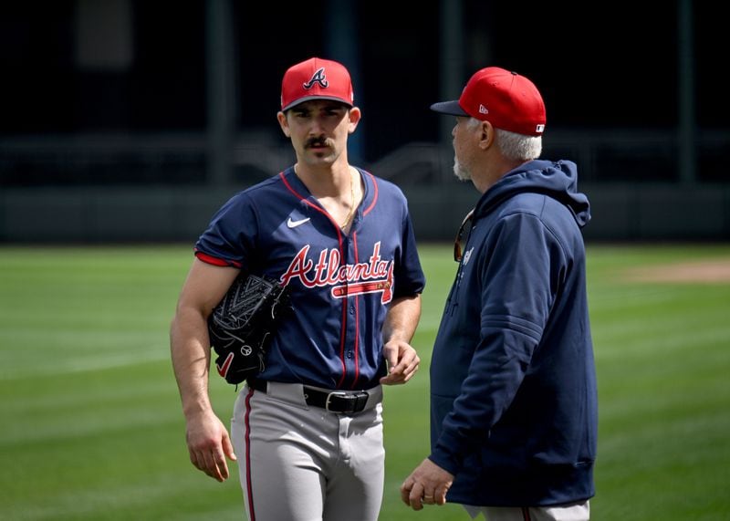 Spencer Strider confers with pitching coach Rick Kranitz during spring training workouts Feb. 19 in North Port, Florida. (Hyosub Shin/hshin@ajc.com)