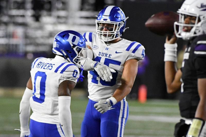 Duke cornerback Chandler Rivers (0) celebrates with linebacker Ozzie Nicholas (45) after he tackled Northwestern quarterback Mike Wright during the second overtime period of an NCAA college football game, Friday, Sept. 6, 2024, in Evanston, Ill. (AP Photo/Matt Marton)