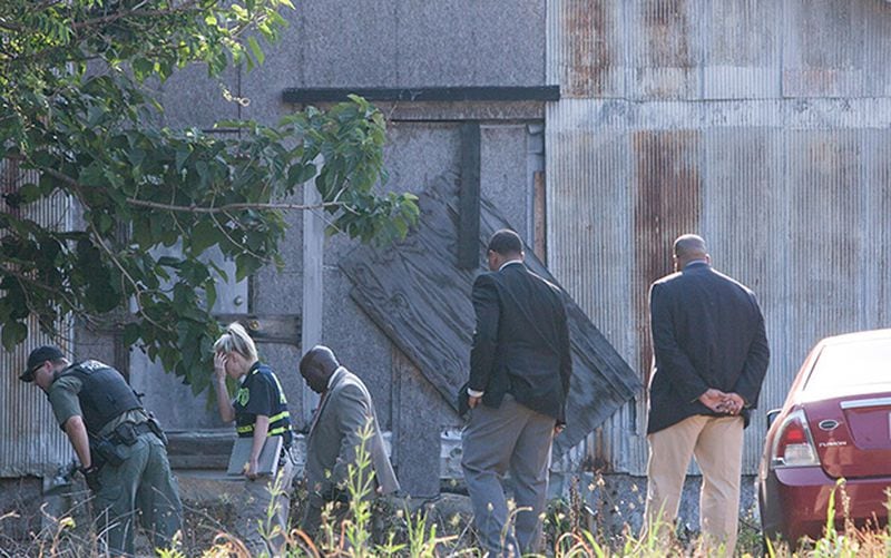 Investigators and GBI work the scene where 19-year-old Bridget Shiel’s car was found behind Crowe’s Plaza, Wed., June 1, 2016, in Stone Mountain. Shiel was shot to death and left naked in Oakland City Park near downtown Atlanta on Tuesday. BRANDEN CAMP / SPECIAL