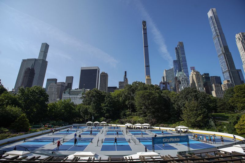 People practice pickleball on the courts of CityPickle at Central Park's Wollman Rink, Saturday, Aug. 24, 2024, in New York. (AP Photo/Eduardo Munoz Alvarez)