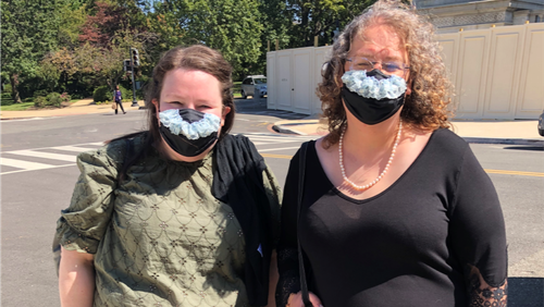 Bridget Miliacca, of Milwaukee, and Rhiannon Davis, of Hobart, Ind., drop to Washington in order to pay respects to Supreme Court  Justice Ruth Bader Ginsburg on Wednesday, Sept. 23, 2020. A friend who makes masks added blue lace in order to mimic the collars Ginsburg often wore with her judicial robe. (Tia Mitchell/AJC)