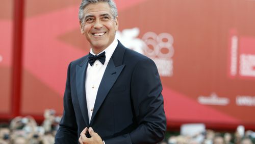 FILE - George Clooney poses on the red carpet at the premiere of his film "The Ides of March," opening the 68th edition of the Venice Film Festival in Venice, Italy on Aug. 31, 2011. (AP Photo/Andrew Medechini, File)