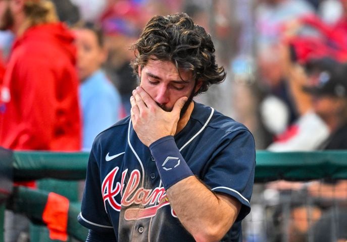 Atlanta Braves shortstop Dansby Swanson (7) is emotional in the dugout as the Philadelphia Phillies celebrate an 8-3 win eliminating Atlanta during game four of the National League Division Series at Citizens Bank Park in Philadelphia on Saturday, October 15, 2022. (Hyosub Shin / Hyosub.Shin@ajc.com)
