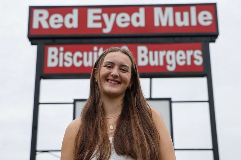 Avery Graus, a senior at Marietta High School poses for a photo outside of Red Eyed Mule in Marietta on Thursday, May 23, 2024. Graus will be receiving free meals for life from the restaurant for having perfect attendance since kindergarten. (Natrice Miller/ AJC)