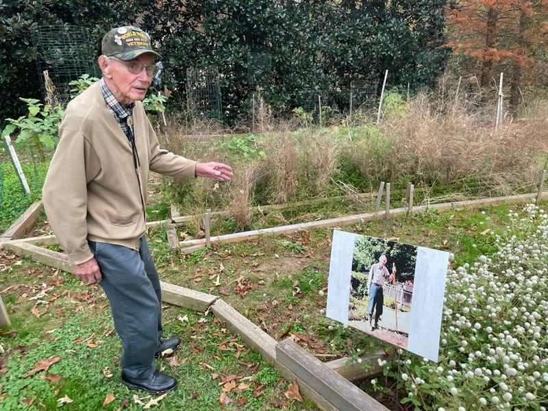 World War II Army vet Robert Ford, 97, tours the terraced garden in the backyard of his Tucker home, where he lives with his daughter and her husband. Yes, that is a photo of him.