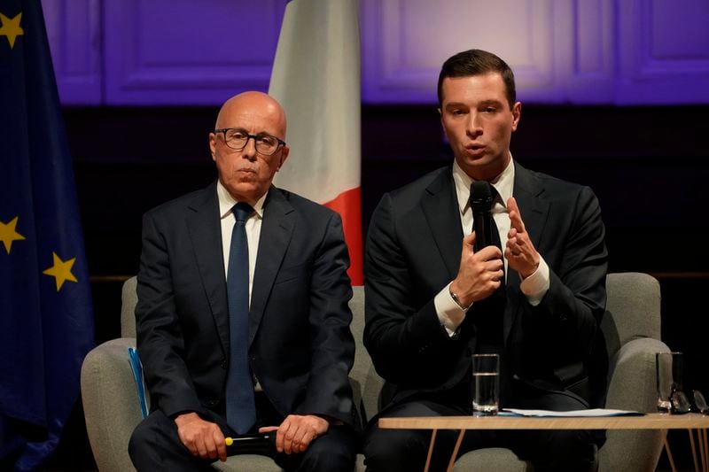 FILE - Eric Ciotti, left, President of the conservative party Les Republicains, and far-right National Rally party president Jordan Bardella attend a meeting with the French business organization (MEDEF), on June 20, 2024 in Paris. From taxing billionaires and making gasoline cheaper to earlier retirement and higher wages, opposing left-right blocs in France's election are making costly campaign promises that are spooking investors as they seek to woo voters and sideline President Emmanuel Macron. (AP Photo/Thibault Camus, File)