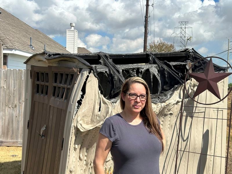 Diane Hutto stands in her home's backyard in Deer Park, Texas, on Thursday, Sept. 19, 2024, next to a shed that had been melted by the intense heat from a massive pipeline fire that erupted near her house earlier this week. (AP Photo/Juan A. Lozano)