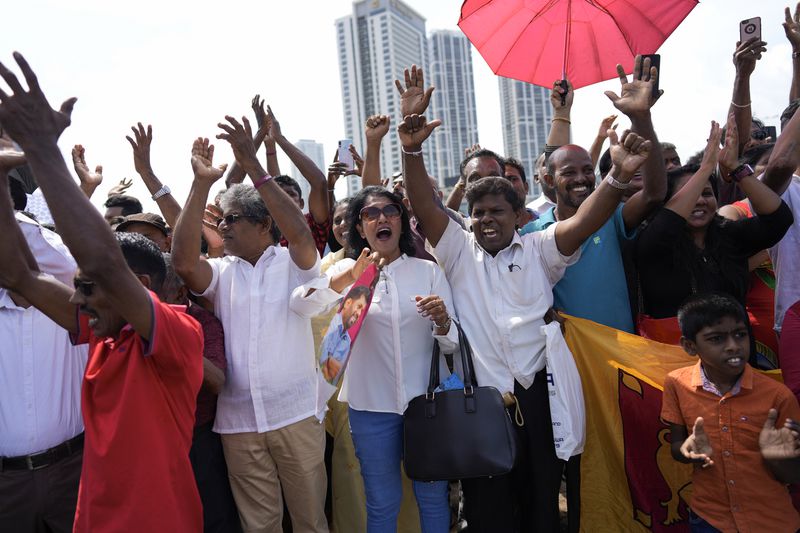 Supporters of Marxist lawmaker Anura Kumara Dissanayake cheer outside the president's office as he arrives to be sworn in as Sri Lanka’s tenth president in Colombo, Sri Lanka, Monday, Sept. 23, 2024. (AP Photo/Eranga Jayawardena)