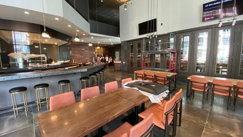 The main dining room at Reverence offers a look at the open kitchen. Other seating options include a lounge and a two-level patio overlooking West Peachtree Street. Ligaya Figueras/ligaya.figueras@ajc.com