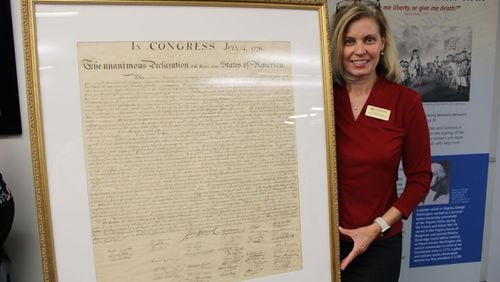 Dr. Catherine Lewis, KSU’s associate vice provost for museums, archives, rare books and the university libraries, with the university’s newly restored copy of the Declaration of Independence from 1843.