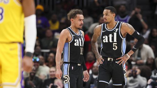 Atlanta Hawks guard Trae Young (11) talks with Atlanta Hawks guard Dejounte Murray (5) during the first half against the Los Angeles Lakers at State Farm Arena, Tuesday, January 30, 2024, in Atlanta. (Jason Getz / jason.getz@ajc.com)