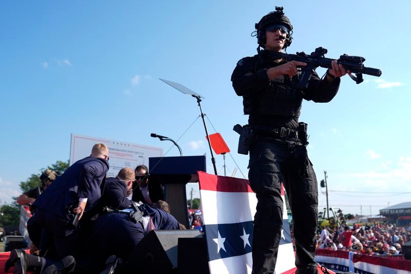 FILE - Republican presidential candidate former President Donald Trump is covered by U.S. Secret Service agents at a campaign rally, July 13, 2024, in Butler, Pa. (AP Photo/Evan Vucci, File)