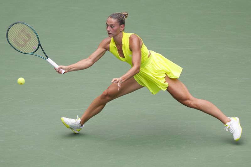 Marta Kostyuk, of Ukraine, returns a shot to Emma Navarro, of the United States, Marta Kostyuk, of Ukraine, during the third round of the U.S. Open tennis championships, Friday, Aug. 30, 2024, in New York. (AP Photo/Matt Rourke)