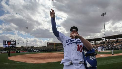 The Los Angeles Dodgers' Justin Turner tosses a ball to fans as he walks off the field during a game against the Chicago White Sox at Camelback Ranch Stadium in Glendale, Ariz., on Friday, Feb. 23, 2018. (Robert Gauthier/Los Angeles Times/TNS)