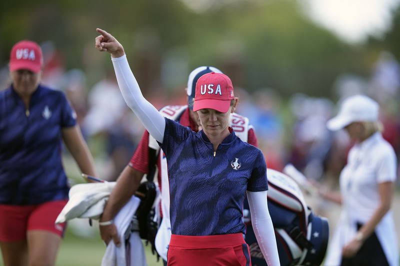 United States' Sarah Schmelzel reacts after putting in on the 14th hole during a Solheim Cup golf tournament fourball match at Robert Trent Jones Golf Club, Friday, Sept. 13, 2024, in Gainesville, Va. (AP Photo/Chris Szagola)