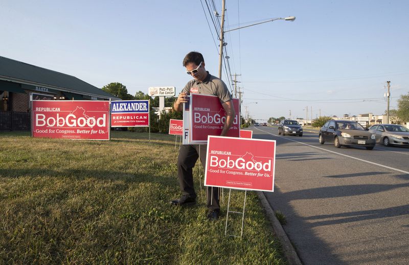 Supporter Phil Hamilton places campaign signs for Rep. Bob Good, a candidate in the Republican primary for the Virginia's 5th Congressional District, along Timberlake Road in Lynchburg, Va., Tuesday, June 18, 2024. (AP Photo/P. Kevin Morley)