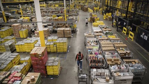 Employees filling online orders at an Amazon distribution center. (Bloomberg photo by Victor J. Blue)