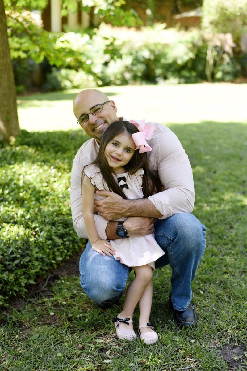 Dr. Enrique Lopez and his coworkers at Phoebe Putney Medical Center in Albany, Georgia are treating a surge of patients with COVID-19, the disease caused by the new coronavirus. For safety’s sake, he lives, eats and sleep separately from his family, FaceTiming with them within the same house. He and his wife tell their three children he has to stay far from them because he’s sick. His daughter, 4, tries to reach for him and doesn’t understand. She is shown here in an earlier photo with Dr. Lopez. (PHOTO courtesy of Dr. Enrique Lopez)