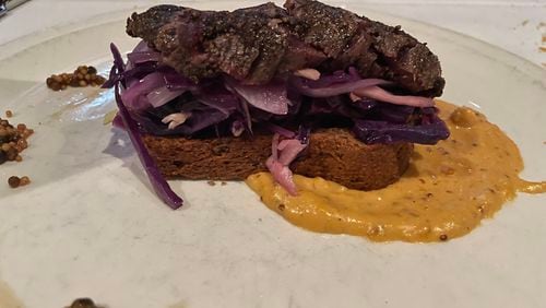 Peppercorn-crusted kangaroo is served on a pumpernickel crouton at Canoe. (Angela Hansberger for The Atlanta Journal-Constitution)