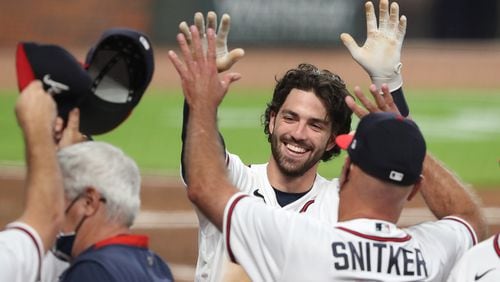 Braves shortstop Dansby Swanson gets a double high five from manager Brian Snitker after hitting a 2-RBI walk-off home run to beat the Washington Nationals 7-6 during the 9th inning in a MLB baseball game on Monday, August 17, 2020 in Atlanta.    Curtis Compton ccompton@ajc.com