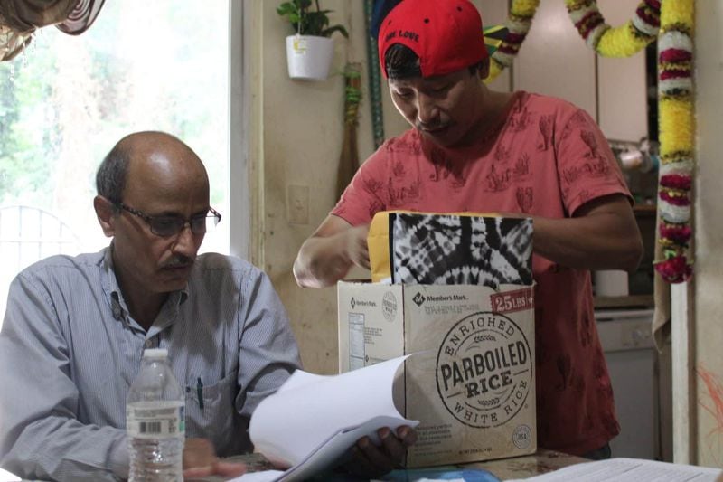 Dil Rai looks through some of his paperwork. (Photo Courtesy of Sophia Qureshi)