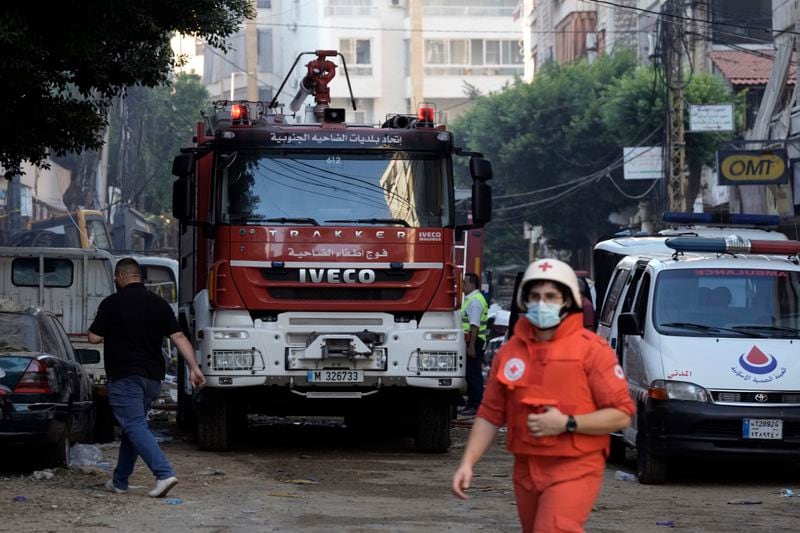 Rescuers at the scene a day after an Israeli missile strike in Beirut's southern suburbs, Saturday, Sept. 21, 2024. (AP Photo/Bilal Hussein)