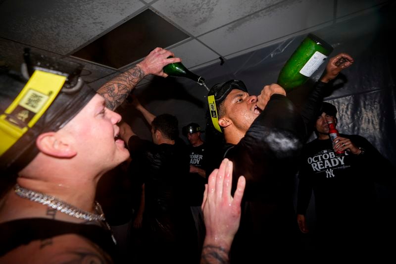 New York Yankees' Alex Verdugo, left, celebrates with Juan Soto, right, after clinching a playoff spot after a 2-1 win over the Seattle Mariners in 10 innings in a baseball game Wednesday, Sept. 18, 2024, in Seattle. (AP Photo/Lindsey Wasson)