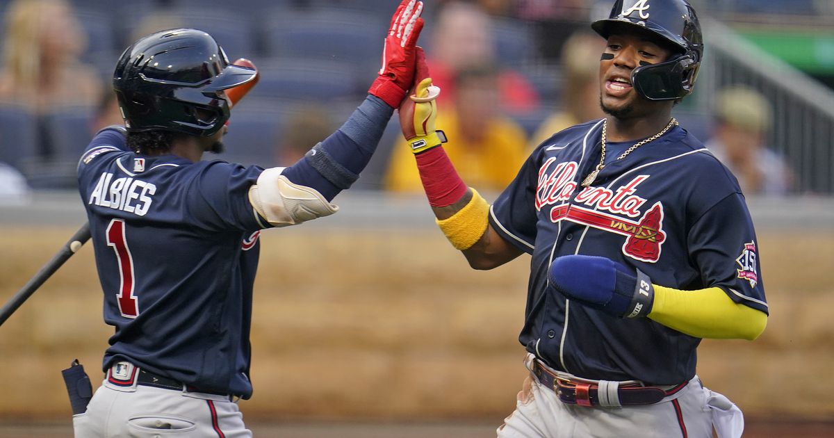 Atlanta Braves' Ronald Acuna Jr. puts on his Nike batting gloves in the  dugout during a baseball game against the Cincinnati Reds in Cincinnati,  Friday, July 1, 2022. The Braves won 9-1. (