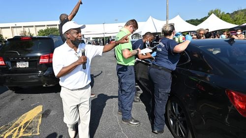 DeKalb County CEO Michael Thurmond encourages residents to get vaccinated during a vaccination event at The Gallery at South DeKalb in Decatur on Saturday, Aug. 13, 2021. The county gave out $100 prepaid debit cards to people who got shots. (Hyosub Shin / Hyosub.Shin@ajc.com)