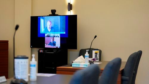 Sean M. Higgins, top, the alleged drunken driver charged with killing NHL hockey player Johnny Gaudreau and his brother Matthew as they bicycled on a rural road, appears before Judge Michael Silvanio, bottom, for his hearing via video from jail, Friday, Sept. 13, 2024, in Woodbury, N.J. (AP Photo/Derik Hamilton)