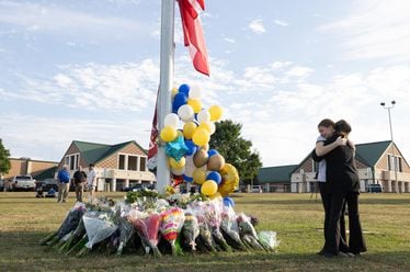 Students embrace near a makeshift memorial at Apalachee High School on Sept. 5, 2024, in Winder, Georgia.  (Jessica McGowan/Getty Images/TNS)