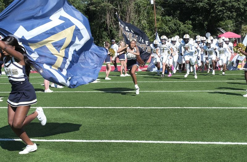 The Apalachee High School football team takes the field led by the cheer squad in their game against Clarke Central on Saturday Sept. 28, 2024 in Georgia.

 Nell Carroll for The Atlanta Journal-Constitution