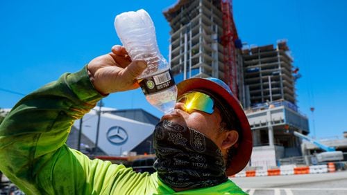 Metal worker Sergio Becerril hydrates after finishing work at a site near the Mercedes-Benz Stadium on Tuesday, June 25, 2024. “I start working at 6:00 am, and by the time I’m done, I probably drink 10 bottles of water,” Becerril said.
(Miguel Martinez / AJC)