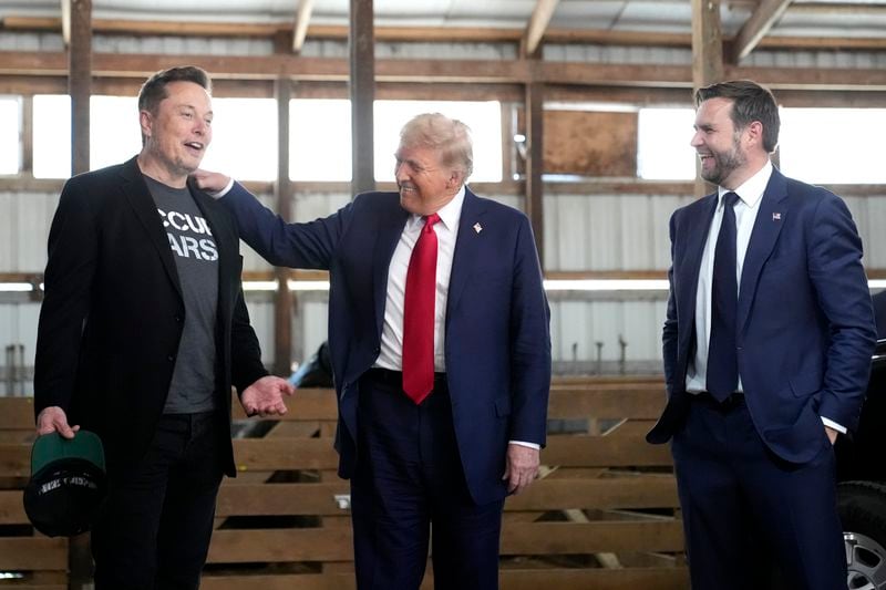 Tesla and SpaceX CEO Elon Musk, from left, Republican presidential nominee former President Donald Trump and Republican vice presidential nominee Sen. JD Vance, R-Ohio, attend a campaign event at the Butler Farm Show, Saturday, Oct. 5, 2024, in Butler, Pa. (AP Photo/Alex Brandon)