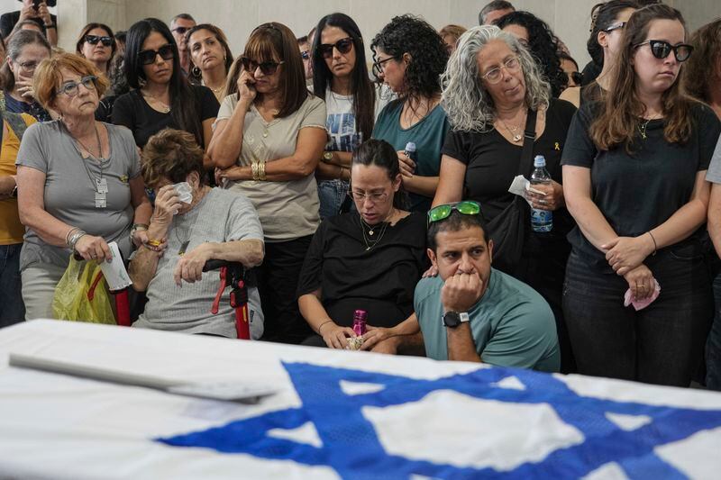 Mourners attend the funeral of Michel Nisenbaum, who was killed during Hamas' Oct. 7 attack and whose body was taken into Gaza, in Ashkelon, Israel, on Sunday, May 26, 2024. The Israeli military recovered Nisenbaum's remains, along with those of two other Israelis killed during the attack, in an operation in Gaza last week. (AP Photo/Tsafrir Abayov)