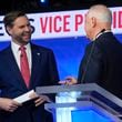 Republican vice presidential nominee Sen. JD Vance, R-Ohio, talks with Democratic vice presidential candidate Minnesota Gov. Tim Walz after the vice presidential debate hosted by CBS News Tuesday, Oct. 1, 2024, in New York. (AP Photo/Matt Rourke)