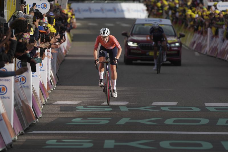 Stage winner Demi Vollering of The Netherlands strains as she sprints to the finish line coming four second short of taking the Tour de France Women's overall win in the eighth stage of the Tour de France Women cycling race with start in Le Grand-Bornand and finish in Alpe d'Huez, France, Sunday, Aug. 18, 2024. (AP Photo/Peter Dejong)