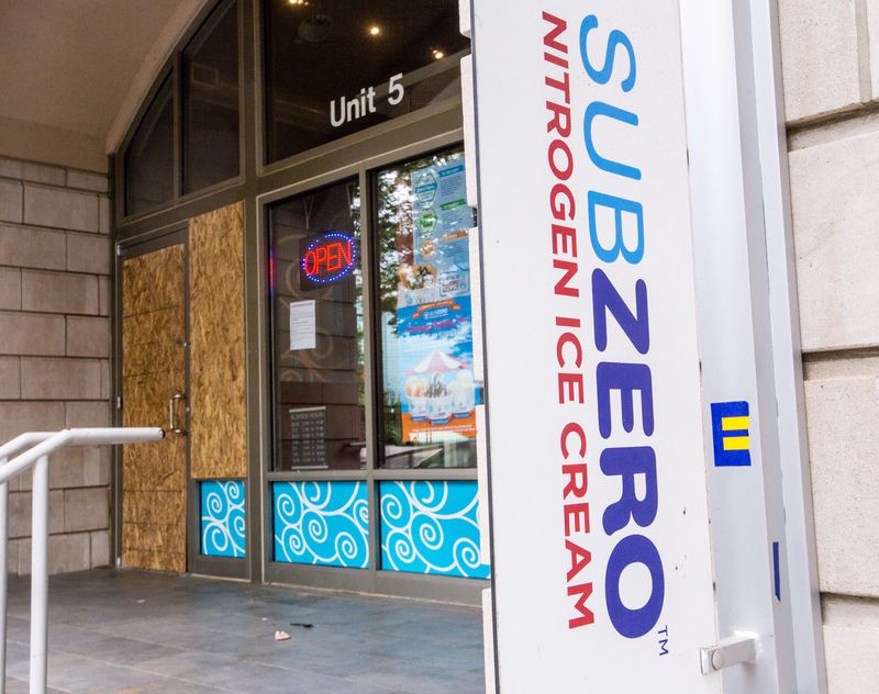 Sub Zero Nitrogen Ice Cream near Centennial Olympic Park sustained damages from rioters and has several broken, boarded-up windows but is still open for business Wednesday, June 17, 2020. (Jenni Girtman for The Atlanta Journal-Constitution)