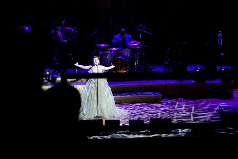 Members of the band Postmodern Jukebox perform on stage at the Ryman Auditorium during a concert in Nashville, Tenn., on July 30, 2024. (AP Photo/Luis Andres Henao)