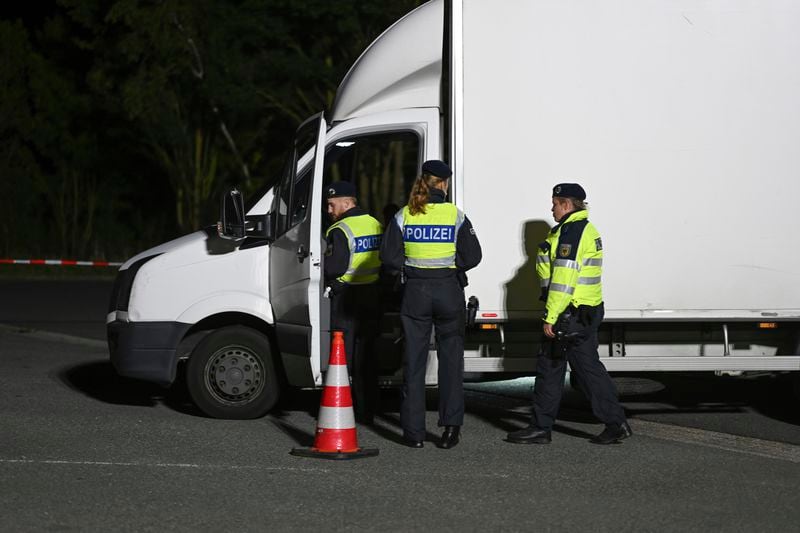 16 September 2024, Lower Saxony, Bunde: Police officers check a van at the Bunderneuland border crossing, in Bunde, Germany Monday, Sept. 16, 2024 as Germany has extended its existing border controls in the east and south of the country to the land border in the west. (Lars Penning/dpa via AP)