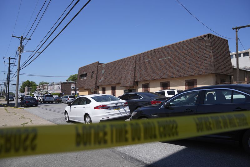 Police tape cordons off the scene of a fatal shooting at Delaware County Linen in Chester, Pa., Wednesday, May 22, 2024. Authorities say a former employee armed with a handgun opened fire at a linen company in a Philadelphia suburb, killing multiple people and wounding three others. (AP Photo/Matt Rourke)