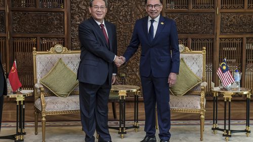 In this photo released by Malaysia's Department of Information, China's Premier Li Qiang, left, shakes hands with Malaysia Prime Minister Anwar Ibrahim before their meeting in Putrajaya, Malaysia, Wednesday, June 19, 2024. (Malaysia's Department of Information via AP)