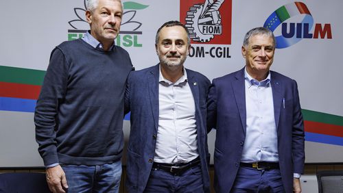 Fernando Uliano of Fim Cisl union, left, Michele De Palma of Fiom Cgil union, centre, and Rocco Palombella of Uilm union pose after announcing the mobilization of Stellantis workers and the entire automotive supply chain, in Rome, Tuesday, Sept. 24, 2024. (Roberto Monaldo/LaPresse via AP)