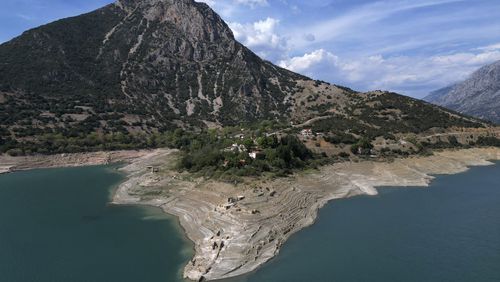 The ruins of the sunken village are seen from above as Kallio village stands on the shores of the artificial Mornos Lake, the biggest of the four reservoirs supplying drinking water to Greece's capital which is at its lowest level in 16 years, some 200 kilometers (125 miles) northwest from Athens, central Greece, on Thursday, Sept. 5, 2024. (AP Photo/Thanassis Stavrakis)