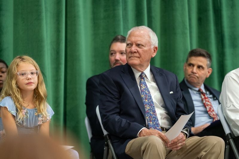 Former Governor Nathan Deal sits on stage. Family, friends and community members gather for the dedication ceremony of Sandra Dunagan Deal Elementary School. Monday, August 26, 2024 (Ben Hendren for the Atlanta Journal-Constituion)