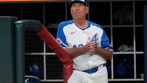 Atlanta Braves manager Brian Snitker (43) watches from the dugout during a baseball game against the Texas Rangers Saturday, April 20, 2024, in Atlanta. (AP Photo/John Bazemore)