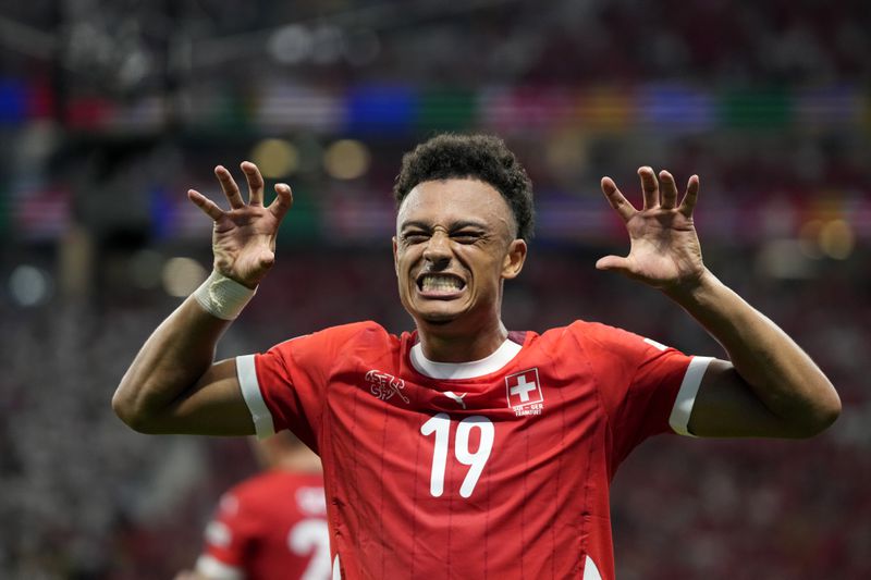 Switzerland's Dan Ndoye celebrates after scoring his sides first goal during a Group A match between Switzerland and Germany at the Euro 2024 soccer tournament in Frankfurt, Germany, Sunday, June 23, 2024. (AP Photo/Themba Hadebe)
